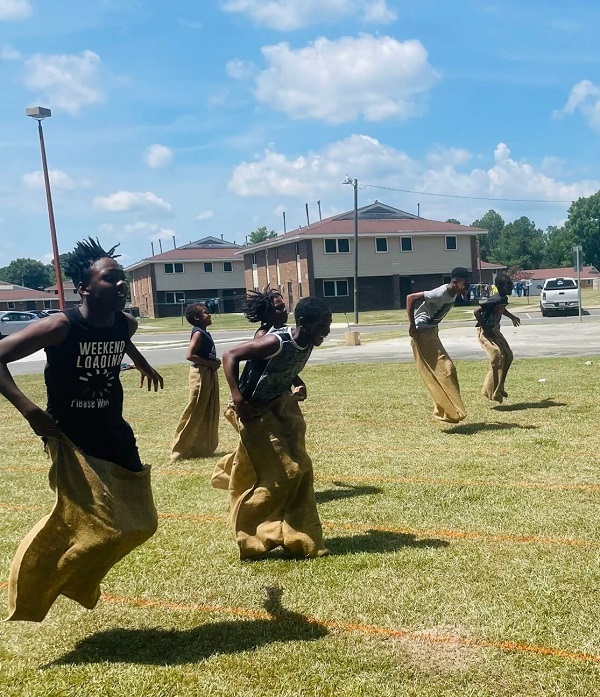 Children participating in the sack race.