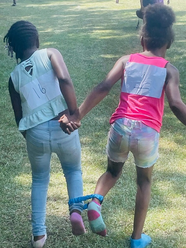 Children participating in the 3-legged race.