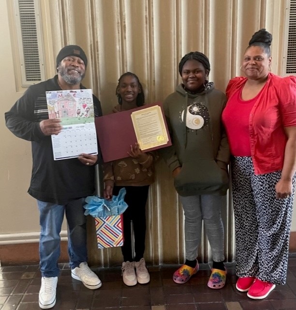 Jada with her family and property manager.