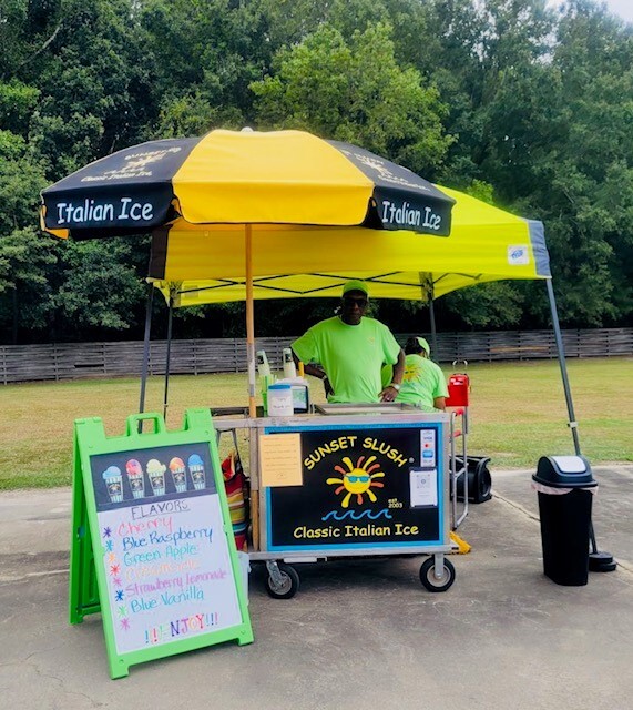 A man behind the Sunset Slush cart.