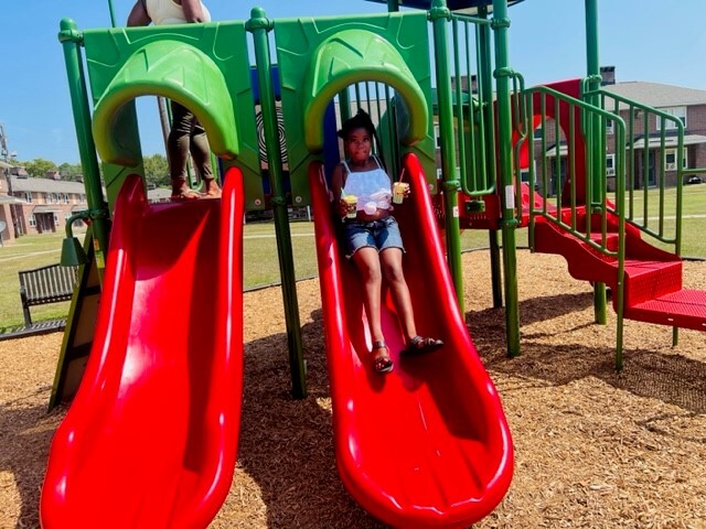 Young lady going down the slide at the new playground.