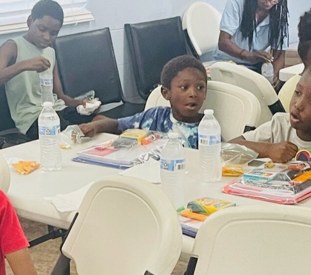 Children with school supplies at the Jack rountree Back to School Event.