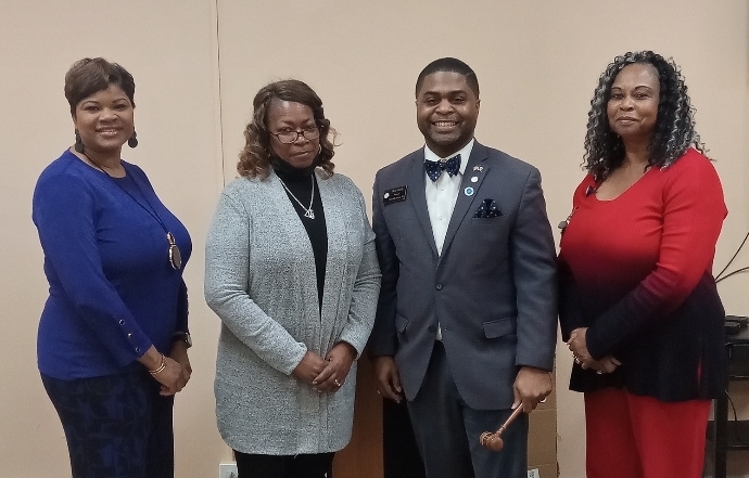 Group of board members standing next to Gwen Wynn.