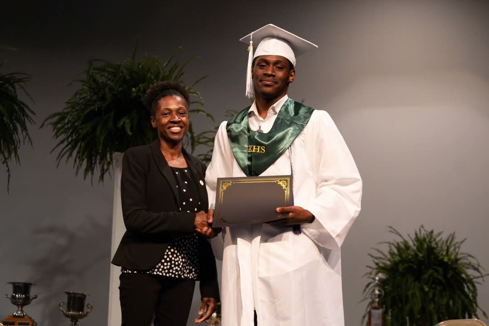 James Sanders, Jr receiving his scholarship on stage.
