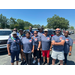  Ten people at the Torch Run, stand and smile for a picture. 
