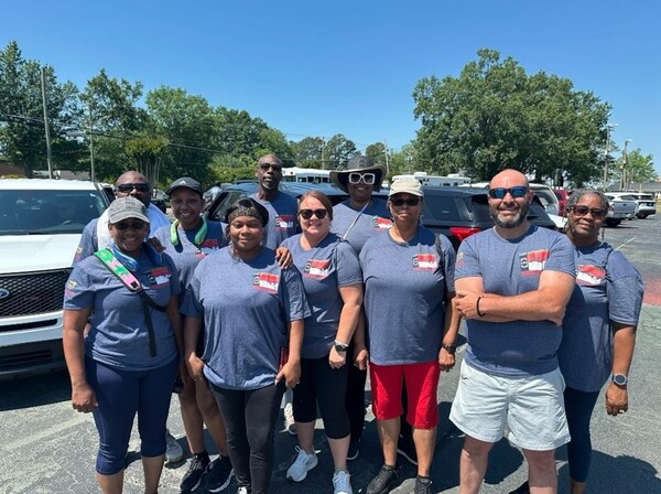 Ten people at the Torch Run, stand and smile for a picture.