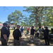  People gathered around a grill. 