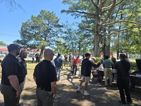 People gathered around a grill.