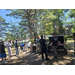  People gathered around a grill. 